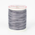 Black and white striped variegated thread on white plastic spool with pink Majestic label, color 437 Zebra pattern