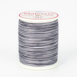 Black and white striped variegated thread on white plastic spool with pink Majestic label, color 437 Zebra pattern