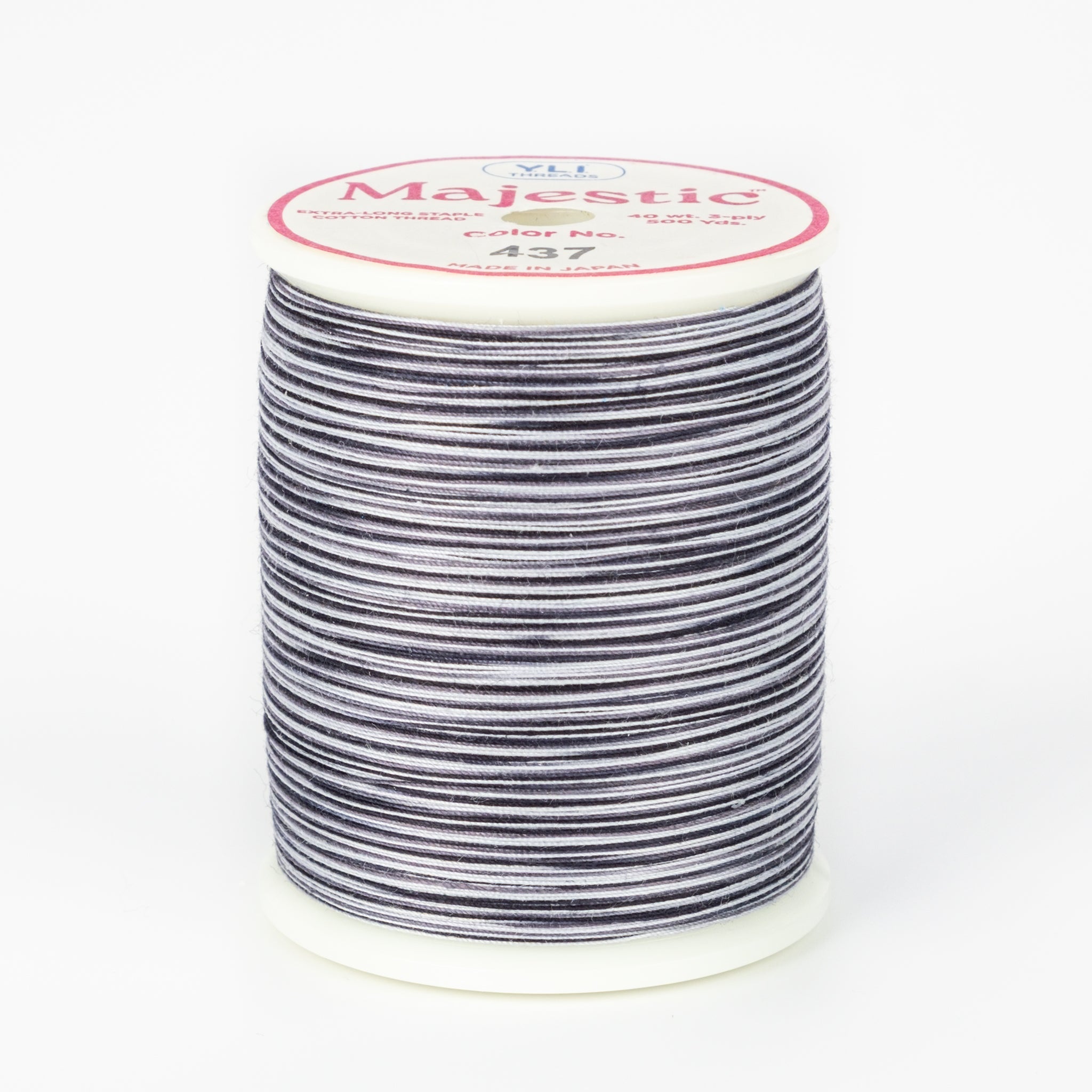 Black and white striped variegated thread on white plastic spool with pink Majestic label, color 437 Zebra pattern