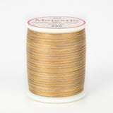 Variegated orange, yellow and gray thread on white spool with Majestic label, color 439 Walkabout