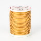 Orange and brown variegated Majestic thread on white spool with pink and white label showing color number 440