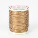 Brown and tan variegated Majestic thread on white plastic spool with pink and white label showing color number 442