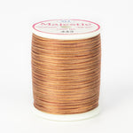 Variegated brown and tan thread on white spool with Majestic label, color 443 Coconut Husk