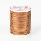 Variegated brown and tan thread on white spool with Majestic label, color 443 Coconut Husk