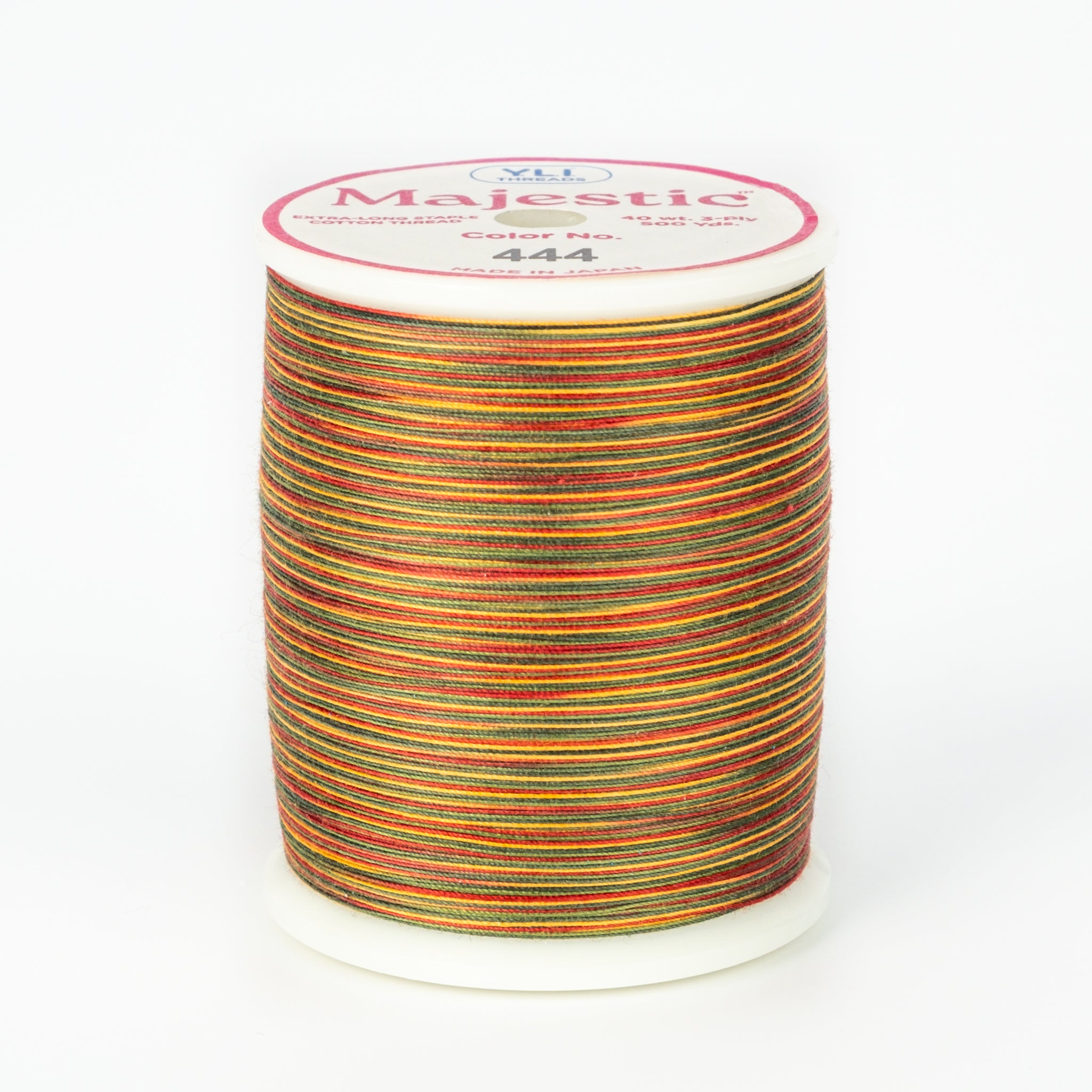 Christmas Gold variegated thread spool with red, green, gold, orange stripes on white plastic spool with Majestic label.