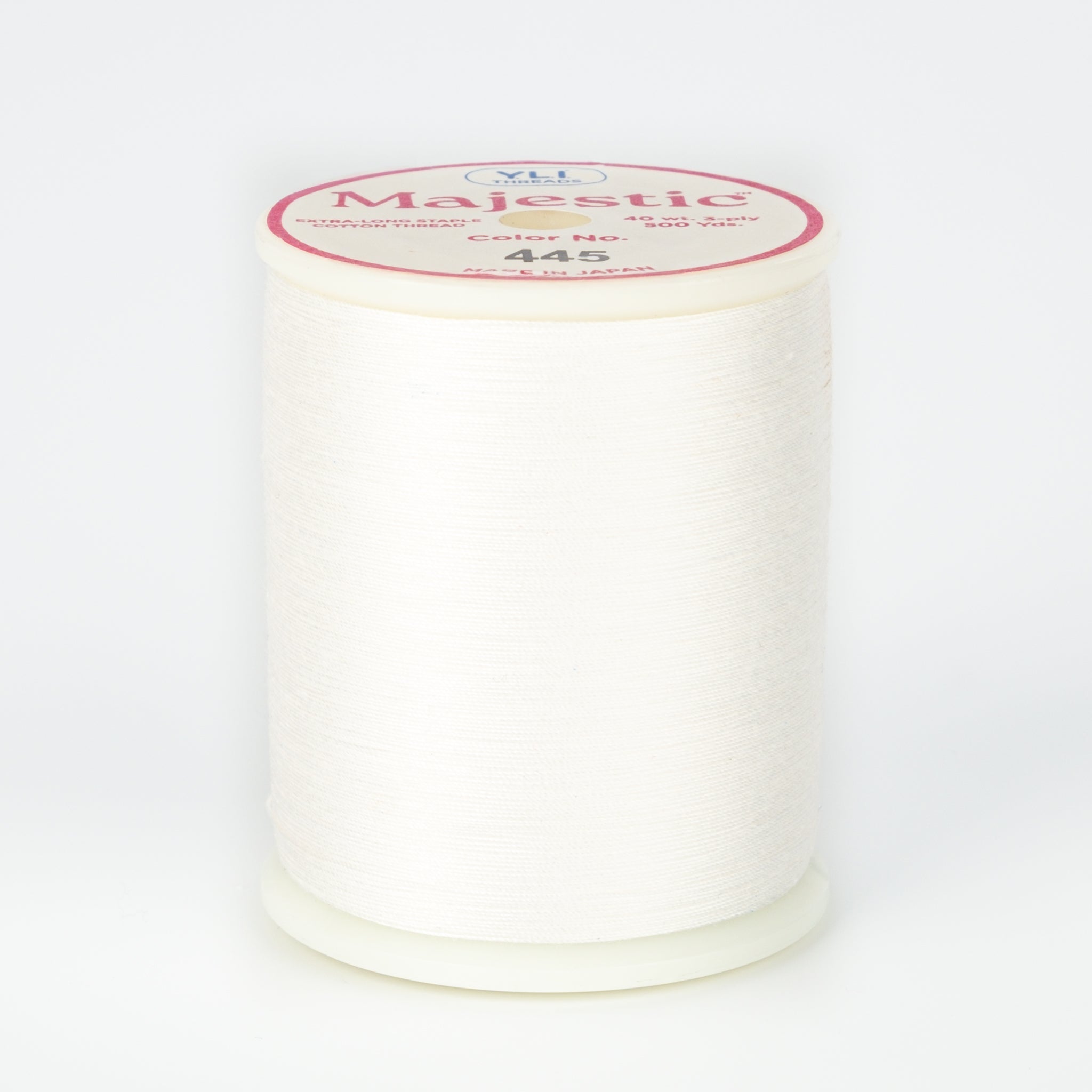 White Majestic thread on plastic spool with pink and white label showing Color No. 445