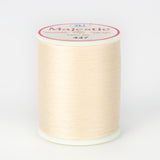 Cream colored Majestic 40 wt thread on white plastic spool with pink and white label showing color number 447