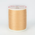 Almond colored thread wound on white plastic spool with Majestic brand label showing color number 448