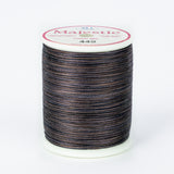 Dark variegated thread spool with navy, brown and gray tones on white plastic spool with Majestic label showing color 449