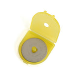 Yellow circular rotary cutter blade in protective plastic case with gray measurement dial and safety cover.