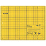 Yellow grid-patterned cutting mat with measurement markings along the edges and Olfa branding in the corner.