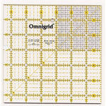 A clear acrylic quilting ruler with yellow grid lines, measurement markings, and the Omnigrid brand name, measuring 6.5 inches square.