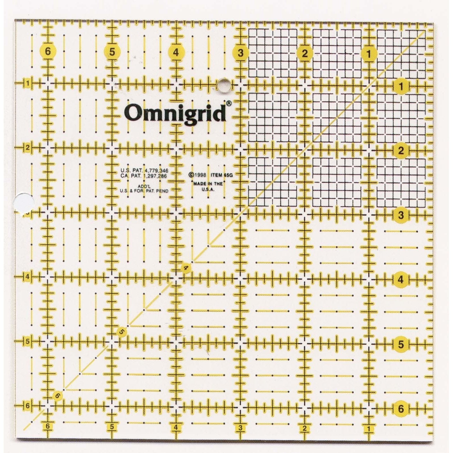 A clear acrylic quilting ruler with yellow grid lines, measurement markings, and the Omnigrid brand name, measuring 6.5 inches square.