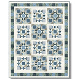 A blue and gray geometric quilt pattern featuring star blocks arranged in a 4x3 grid with coordinating borders.