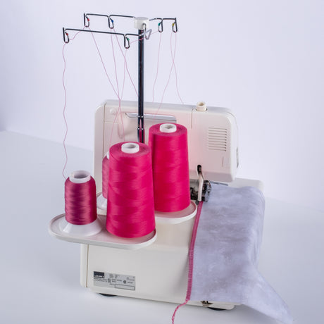 serger with pink cones of woolly nylon and UU thread