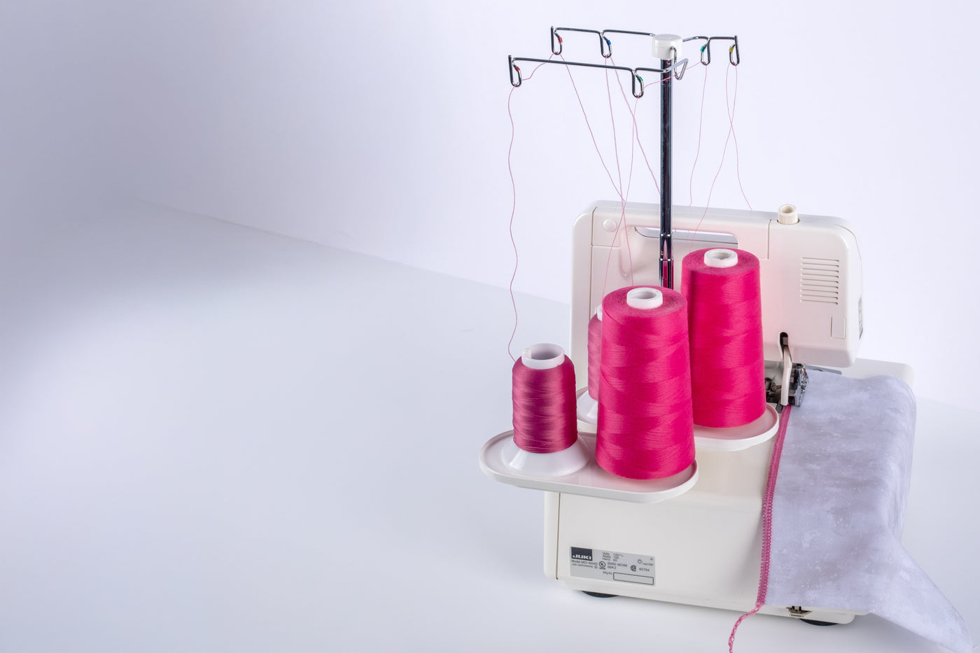 serger with pink cones of woolly nylon and UU thread