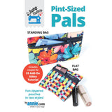 Colorful zippered pouches in two styles - a standing bag with tropical floral print and a flat bag with geometric squares pattern.