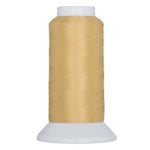 Light gold thread wound on white plastic cone spool with wide base