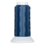 Deep blue thread cone with white plastic cap and base, showing neatly wound polyester thread