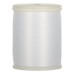 White thread wound on plastic spool with cream-colored end caps
