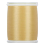 Light gold thread wound on white plastic spool with smooth, lustrous finish
