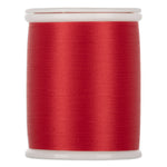 Red thread wound on white plastic spool with smooth, even wrapping and glossy finish