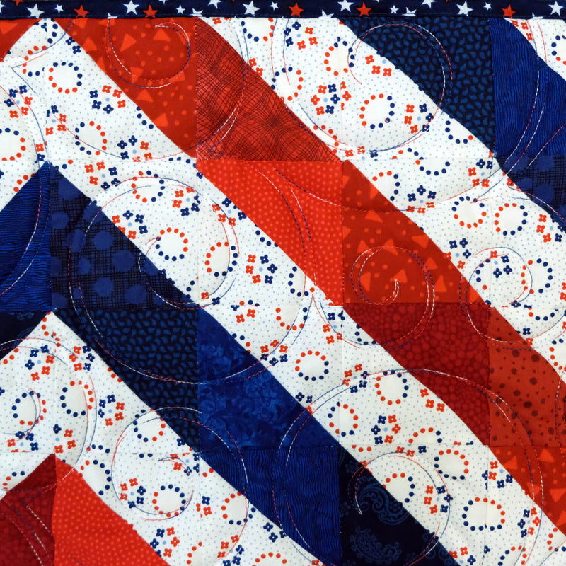 red, white, and blue quilt block with decorative stitching