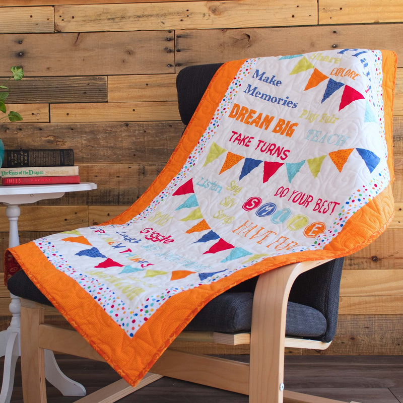 orange and white panel quilt on a rocking chair