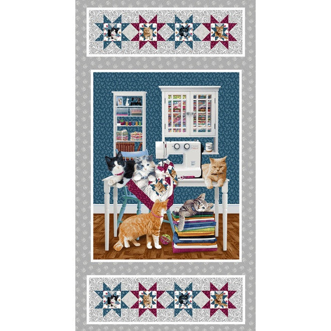 Quilted fabric panel featuring cats in a sewing room scene with star-patterned borders in teal, burgundy, and cream colors.
