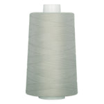 Light sage green thread wound on a white plastic cone spool