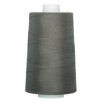 Charcoal gray thread wound on a large white cone spool