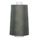 Charcoal gray thread wound on a large white cone spool