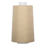 Almond colored thread wound on white plastic cone with neat, even layers visible