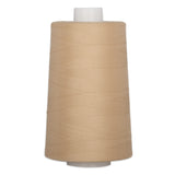 Champagne colored thread wound on a large white plastic cone spool
