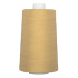 Granola-colored thread wound on white plastic cone, showing smooth polyester thread texture