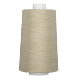 Light oak colored quilting thread wound on white plastic cone spool