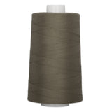 Armor colored thread wound on white plastic cone, showing diagonal thread wrapping pattern