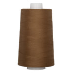 Brown quilting thread wound on white plastic cone spool