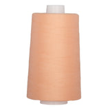 Warm peach polyester quilting thread on white cone spool
