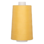 Large cone of golden yellow polyester quilting thread on white plastic spool