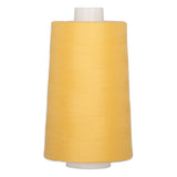 Large cone of golden yellow polyester quilting thread on white plastic spool