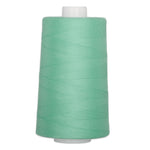 Emerald green quilting thread on white cone spool, 40 weight polyester thread for sewing and quilting projects.