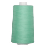 Emerald green quilting thread on white cone spool, 40 weight polyester thread for sewing and quilting projects.