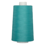 Turquoise polyester quilting thread on white cone spool, 6000 yards