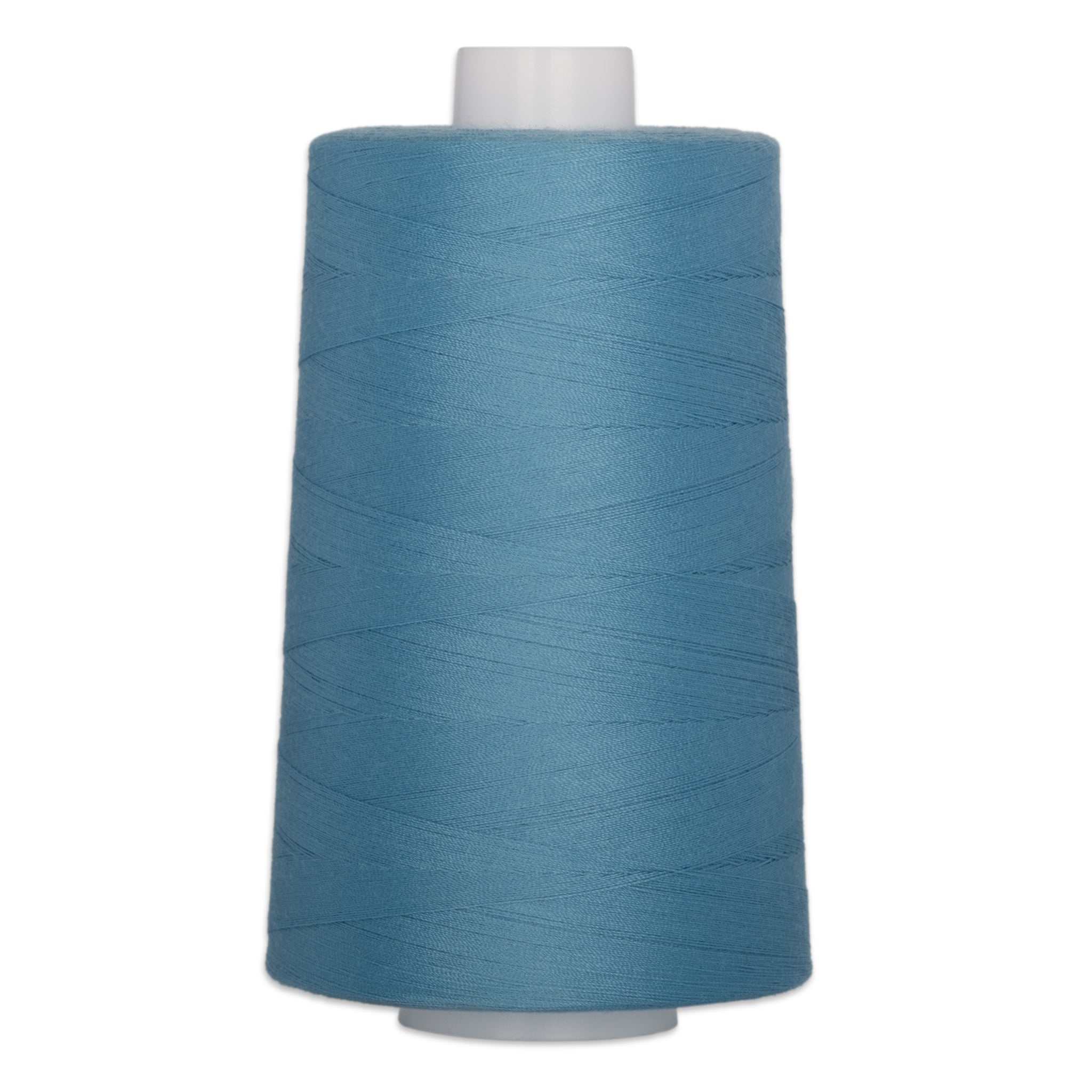 Large cone of blue polyester quilting thread on white plastic spool for sewing and quilting projects.
