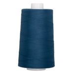 Large cone of patriot blue polyester quilting thread on white spool with visible thread windings.