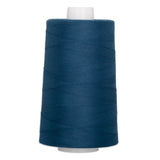 Large cone of patriot blue polyester quilting thread on white spool with visible thread windings.