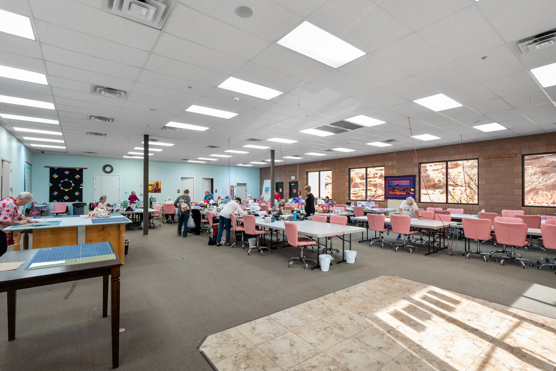 Large room with tables and chairs, possibly a meeting or conference area.