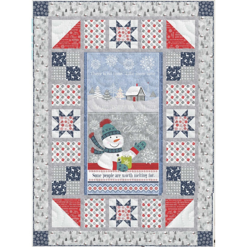 Winter-themed quilt featuring a snowman panel surrounded by star blocks and coordinating fabrics in red, blue, and gray with snow and tree patterns.
