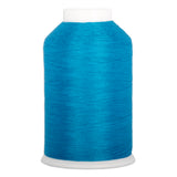 Turquoise thread wound on white plastic cone with smooth, even texture